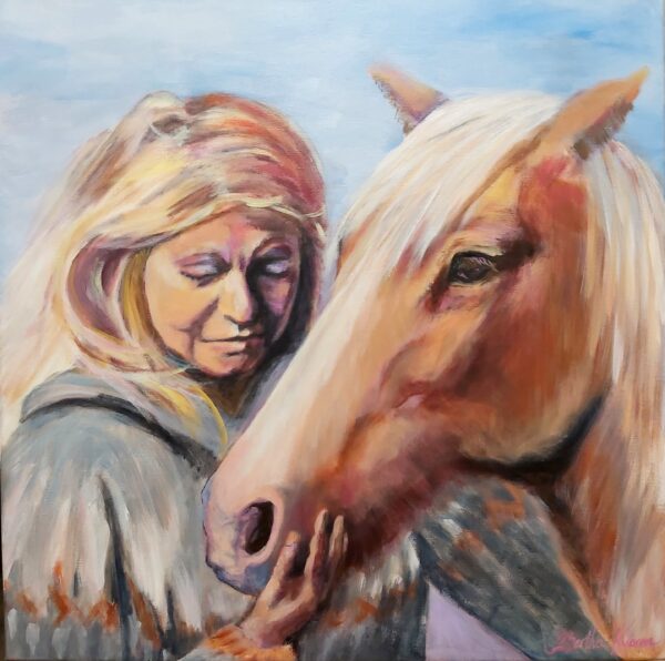 Portrait of a beautiful woman with a horse