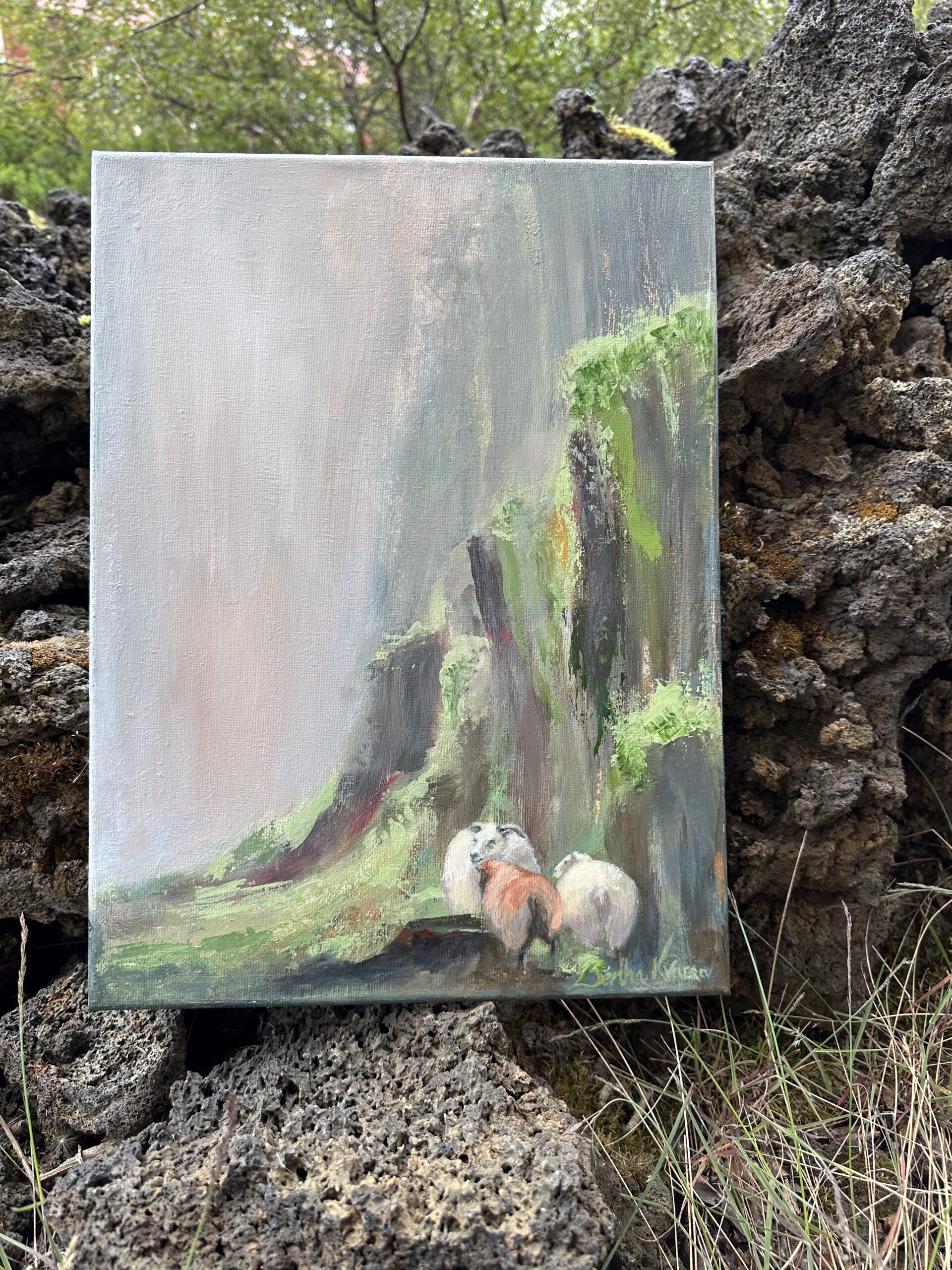 Í vari, a small painting of Icelandic sheep with her two lambs, seeking shelter by the rocks, by Bertha Kvaran ART